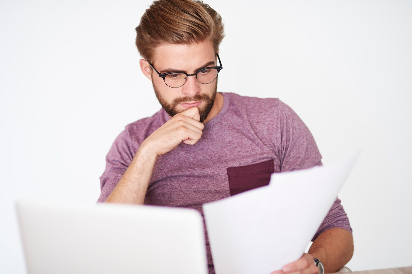 Real estate broker reviewing documents on a laptop