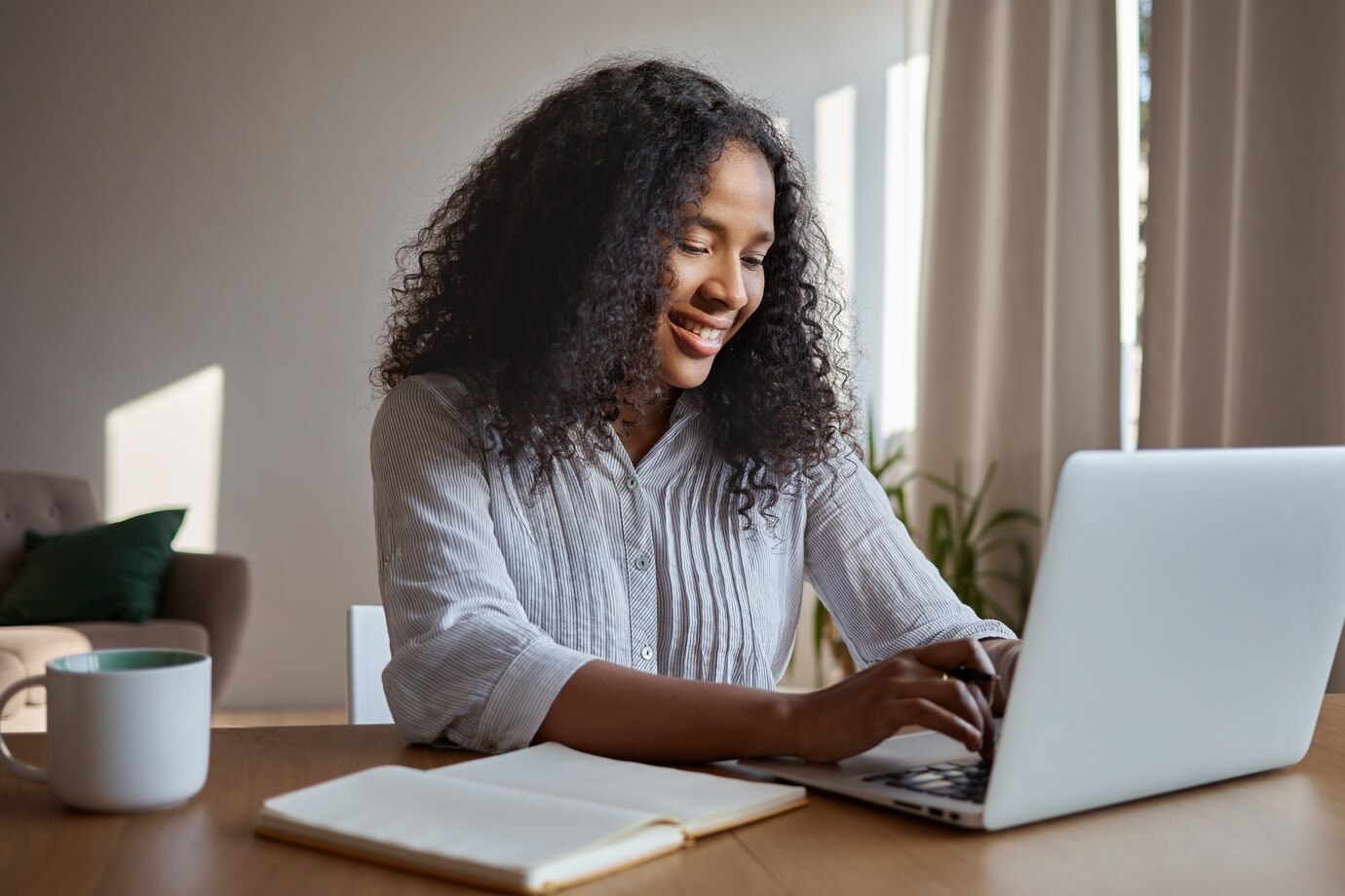 Real estate agent writing a property listing on a laptop
