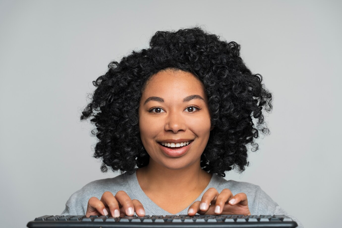 Person typing a property description on a laptop